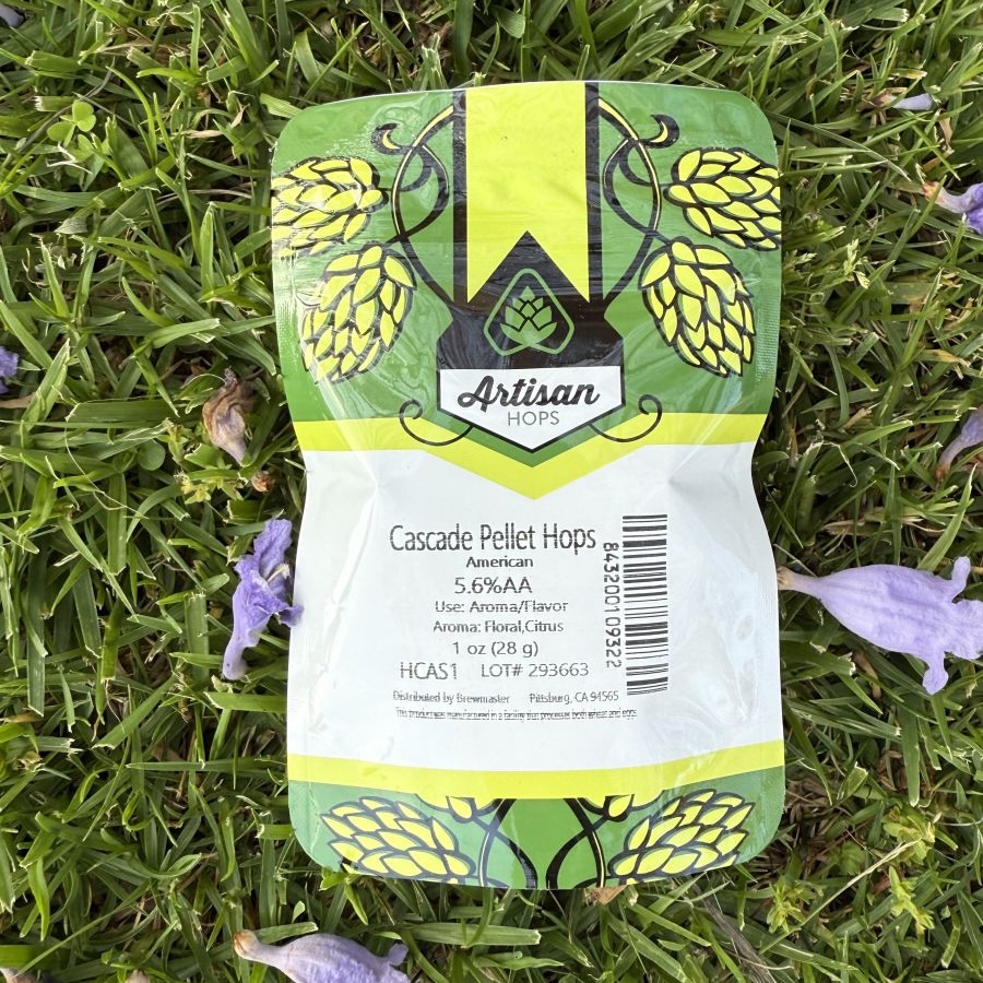 A person holding hop cones